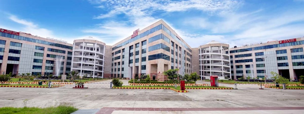 Front view of the AIIMS main hospital building featuring modern architecture, glass façade, and central entrance.